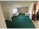 Inviting living room with green carpet and plenty of natural light at 6012 Landover Blvd, Spring Hill, FL 34609
