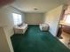 Bright living room featuring neutral walls and green carpeting at 6012 Landover Blvd, Spring Hill, FL 34609
