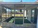Screened patio with green turf, offering views of the neighborhood at 6012 Landover Blvd, Spring Hill, FL 34609