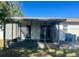 View of the screened in patio with sliding glass door access to the home at 6012 Landover Blvd, Spring Hill, FL 34609