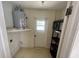 Functional utility room featuring a water heater and shelving for efficient storage at 6012 Landover Blvd, Spring Hill, FL 34609