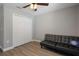 Bedroom with a black futon, laminate floors, a ceiling fan, and a double-door closet at 604 Kinnear Dr, Brooksville, FL 34601