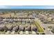 Neighborhood aerial view showcasing tree lined street and community, including several homes and a school at 6068 Apple Snail Ave, New Port Richey, FL 34653