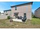 Grassy backyard featuring a patio, outdoor seating, grill and fire pit at 6068 Apple Snail Ave, New Port Richey, FL 34653