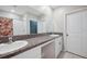 Bathroom featuring double sinks, granite countertops, and ample cabinet space at 6068 Apple Snail Ave, New Port Richey, FL 34653