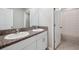 Clean bathroom with double sinks, granite countertops, and a shower with patterned curtains at 6068 Apple Snail Ave, New Port Richey, FL 34653