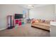 Cozy bedroom features a daybed, storage shelves, and a ceiling fan at 6068 Apple Snail Ave, New Port Richey, FL 34653