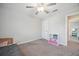 Bright bedroom with ceiling fan and shelves for storage at 6068 Apple Snail Ave, New Port Richey, FL 34653