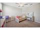 Bright bedroom featuring a bed, desk, and vanity, offering a comfortable and functional space at 6068 Apple Snail Ave, New Port Richey, FL 34653