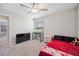 Comfortable bedroom with ceiling fan, television, fish tank, and large window at 6068 Apple Snail Ave, New Port Richey, FL 34653