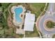 Aerial view of community pool featuring unique design, lounge seating, and inviting surroundings at 6068 Apple Snail Ave, New Port Richey, FL 34653