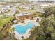 Community pool aerial view featuring a covered picnic pavilion and plenty of space to relax with friends and Gathering at 6068 Apple Snail Ave, New Port Richey, FL 34653