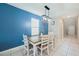 Dining Room features modern light fixture and blue accent wall at 6068 Apple Snail Ave, New Port Richey, FL 34653