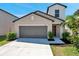 Charming home featuring a two-car garage and landscaped front yard at 6068 Apple Snail Ave, New Port Richey, FL 34653