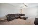 A cozy living room with a plush sectional sofa, soft carpet, and ample natural light at 6068 Apple Snail Ave, New Port Richey, FL 34653