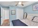 Bright bedroom featuring a ceiling fan, ample closet space, and soothing wall color at 6420 Cabbage Ln, New Port Richey, FL 34653