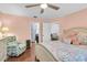 Well-lit bedroom with hardwood floors and access to both the bathroom and closet at 6420 Cabbage Ln, New Port Richey, FL 34653