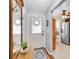 Entryway with a mirror, coat rack, and a view of the kitchen and dining area at 6420 Cabbage Ln, New Port Richey, FL 34653