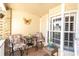 Enclosed front porch area with seating, decor, and a bright, airy ambiance at 6420 Cabbage Ln, New Port Richey, FL 34653