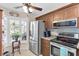 Bright kitchen with stainless steel appliances, a corner window and tile backsplash at 6420 Cabbage Ln, New Port Richey, FL 34653