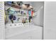 Functional laundry room with appliances and shelving for storage at 6420 Cabbage Ln, New Port Richey, FL 34653