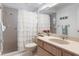 Bathroom featuring a shower, vanity with sink, and ample lighting at 6530 Pine Meadows Dr, Spring Hill, FL 34606