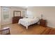 Bright bedroom with hardwood floors, dresser, and comfortable bedding at 6530 Pine Meadows Dr, Spring Hill, FL 34606