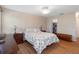 Comfortable bedroom with hardwood floors, large bed, and closet access at 6530 Pine Meadows Dr, Spring Hill, FL 34606