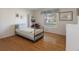 Bright bedroom features hardwood floors, built-in shelves, and a comfortable single bed at 6530 Pine Meadows Dr, Spring Hill, FL 34606