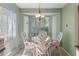 Cozy breakfast nook featuring bay window, chandelier, and seating for casual dining experiences at 6530 Pine Meadows Dr, Spring Hill, FL 34606