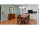 Dining room boasts wood floors, chandelier lighting, and a cozy atmosphere for memorable meals at 6530 Pine Meadows Dr, Spring Hill, FL 34606