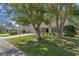 Residential street view of home with brick driveway and mature trees at 6530 Pine Meadows Dr, Spring Hill, FL 34606