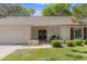 Inviting front entrance with brick accents, decorative seating, and a well-manicured lawn at 6530 Pine Meadows Dr, Spring Hill, FL 34606