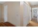 Hallway featuring multiple closets, hardwood floors, and neutral paint at 6530 Pine Meadows Dr, Spring Hill, FL 34606
