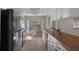 Bright kitchen with updated appliances, white cabinetry, and a cozy breakfast nook by bay windows at 6530 Pine Meadows Dr, Spring Hill, FL 34606
