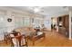 Comfortable living room featuring hardwood floors, large windows, and stylish furnishings for relaxation at 6530 Pine Meadows Dr, Spring Hill, FL 34606