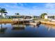 Waterfront home featuring a dock and boat lift for easy access to water at 6536 Beach Blvd, Hudson, FL 34667