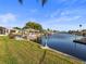 Expansive waterfront view showcasing boat lift, dock, and serene canal living, ideal for boating enthusiasts at 6536 Beach Blvd, Hudson, FL 34667