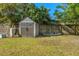 Backyard featuring a convenient storage shed, kayak, and grassy lawn at 7240 Creek Dr, New Port Richey, FL 34655