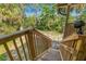 Wooden stairs lead to a lovely backyard space featuring lush greenery and outdoor access at 7240 Creek Dr, New Port Richey, FL 34655