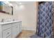 Bathroom featuring tile floor, shower stall with decorative curtains, and a white vanity at 7240 Creek Dr, New Port Richey, FL 34655