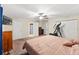 Primary bedroom featuring ensuite bath, carpeted floors, and ceiling fan at 7240 Creek Dr, New Port Richey, FL 34655