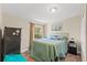 Cozy bedroom features a comfortable bed, ample natural light from the window, and a decorative art piece at 7240 Creek Dr, New Port Richey, FL 34655