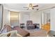 Inviting bedroom with a comfortable recliner, futon, neutral color scheme, and a ceiling fan at 7240 Creek Dr, New Port Richey, FL 34655