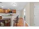 Open kitchen features granite countertops, wooden cabinets, a hardwood floor and eat-in bar seating at 7240 Creek Dr, New Port Richey, FL 34655
