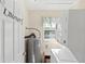 Compact laundry room features a stacked washer and dryer, water heater and storage space at 7240 Creek Dr, New Port Richey, FL 34655