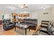Comfortable living room with hardwood floors, recessed lighting, and luxurious leather furniture at 7240 Creek Dr, New Port Richey, FL 34655