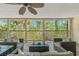 Enjoy the peaceful views and comfy wicker patio seating with this covered outdoor space at 7240 Creek Dr, New Port Richey, FL 34655