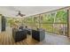 Relaxing covered patio with ceiling fan features wicker furniture and peaceful outdoor views at 7240 Creek Dr, New Port Richey, FL 34655