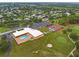 Aerial view of community center featuring a pool, tennis courts, and parking at 7506 Moriah Ave, Brooksville, FL 34613